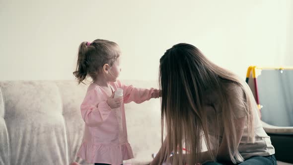 Portrait Young Mother and Sweet Baby Playing Daughter Gives Mom a Toy Pill