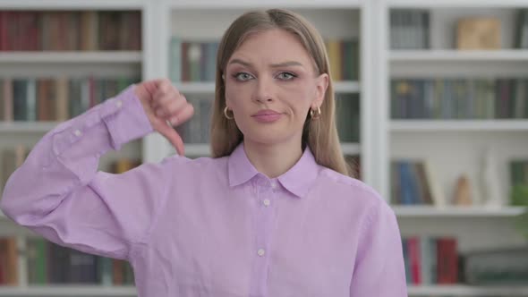 Portrait of Woman Showing Thumbs Down Gesture