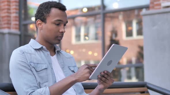 Online Shopping By African Man on Tablet