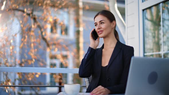 Happy Businesswoman Talking Use Smartphone Sitting on Terrace