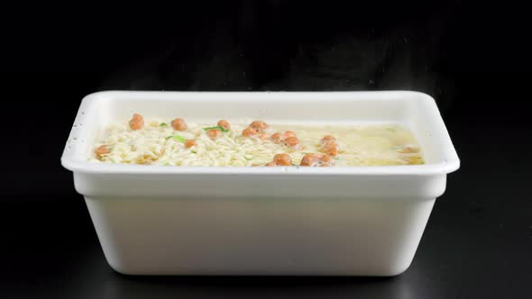 Instant Noodles in a Disposable Plate on Black Background