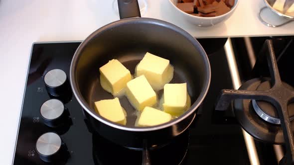 Melting and Mixing a Piece of Butter in a Saucepan on the Gas Stove Butter Becoming Liquid