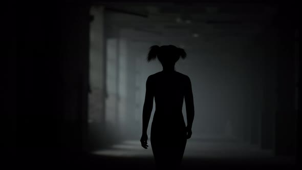 Female Athlete Walking in Corridor