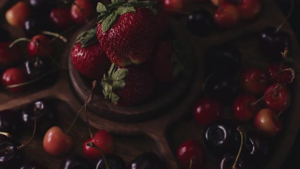 Menazhnitsa with Red Strawberries and Cherries on a Dark Background