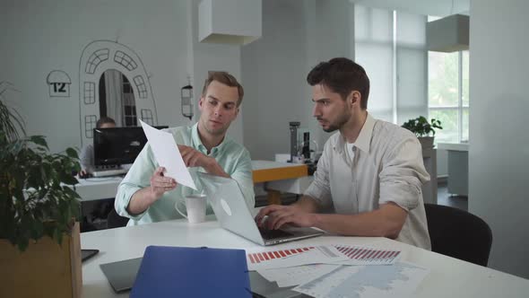 Business Team Working Concentrated on a Presentation.