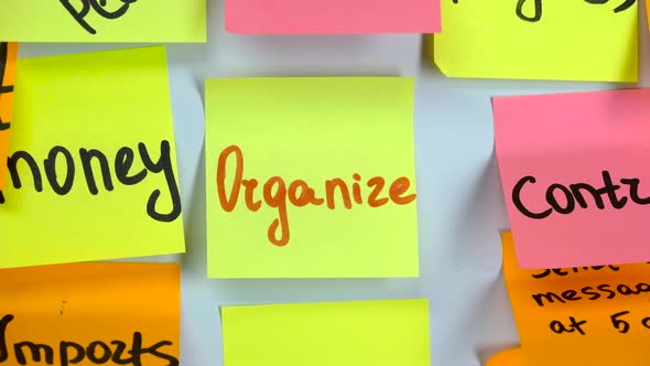 Sticker with the Word Organize Stick on a White Board