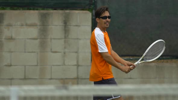 Two men playing outdoor tennis together.