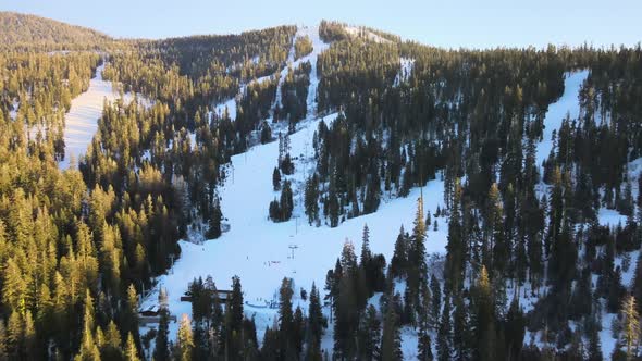 Drone birdseye wideangle footage over ski resort on a bright cloudless day in Lake Tahoe, USA, showi