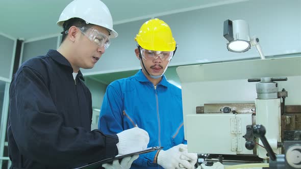 Professional engineering walking discuss inspecting with engineer team machinery factory area.