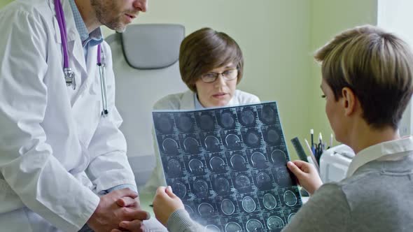 Doctors Explaining CT Scan to Patient