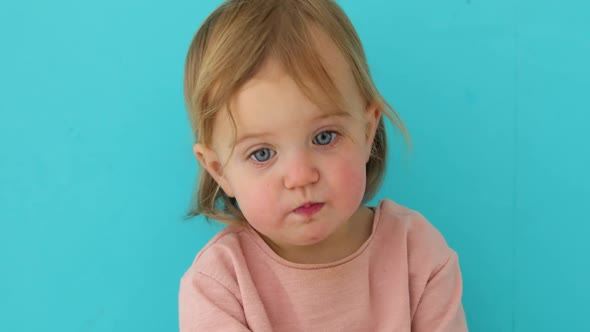 Baby Portrait of Child Isolated on Blue Background