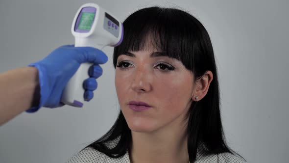 Young Woman Getting Her Temperature Test