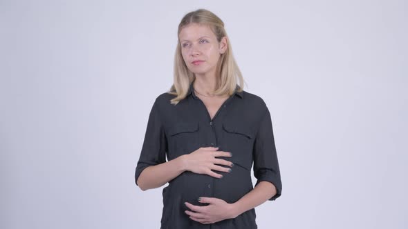 Young Happy Pregnant Businesswoman Thinking and Looking Up