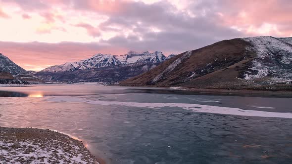 Aerial view of ice sheets broken on lake during sunset