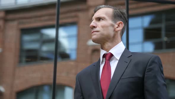 Pensive Businessman Outside Office