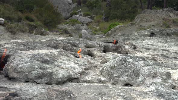 Flame of Methane Underground Emerges From Crack Between Rocks and Burns to Earth