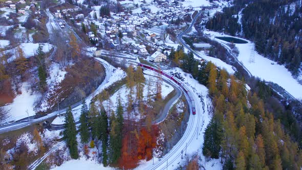 A Train in Switzerland Departing a Village to Transport Tourists and Commuters