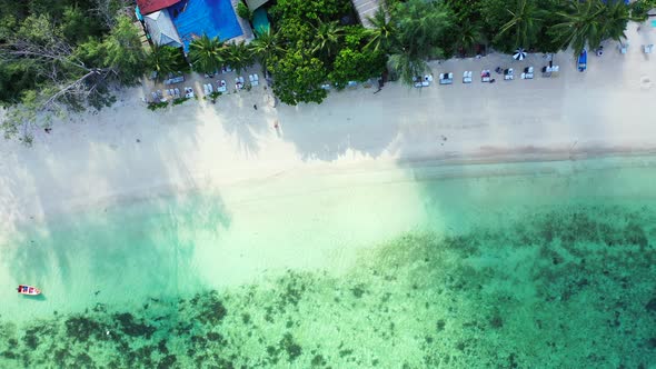 Natural overhead copy space shot of a sandy white paradise beach and blue ocean background