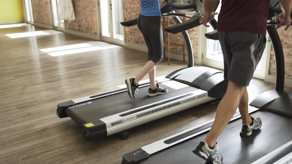 Man and woman exercising in gym