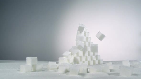 Rewind slow-motion stack of sugar cubes falls