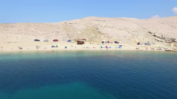 Aerial view of tourists on isolated beach of Pag island, Croatia