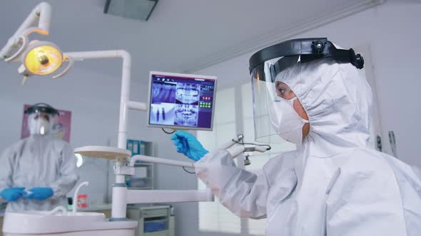 Patient Pov of Dentist in Ppe Suit Measuring Person Temperature