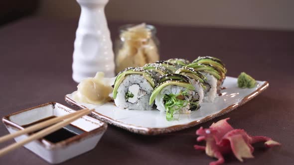 Beautifully served sushi on a white clay plate in the restaurant