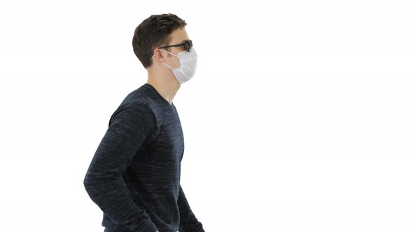 Young Blind Person with Long Cane and Medical Mask Walking on White Background