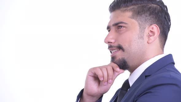 Closeup Profile View of Happy Bearded Persian Businessman Thinking