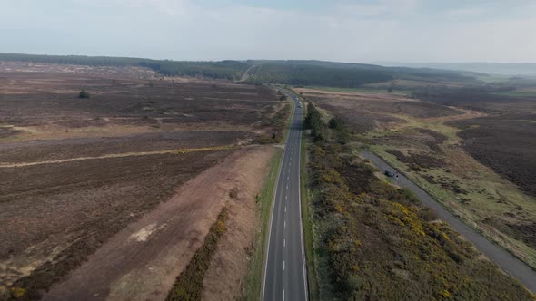 Aerial view above long straight road through rural Goathland North Yorkshire peaceful moors countrys