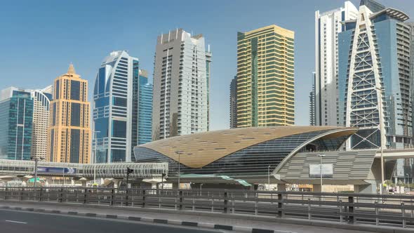 View of Jumeirah Lakes Towers Skyscrapers and Metro Sration Timelapse with Traffic on Sheikh Zayed