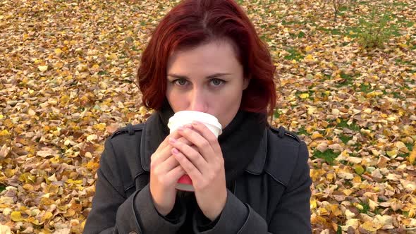 Close View: Young Woman Drinks Coffee Outdoors