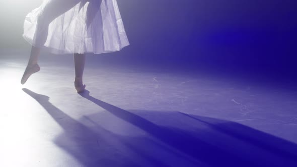 Ballerina Legs Closeup Dancing on Blue Background