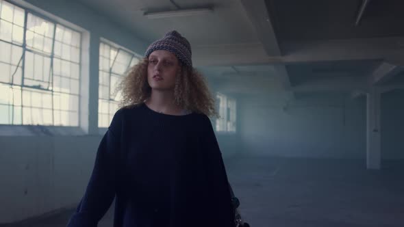 Fashionable young woman in an abandoned warehouse