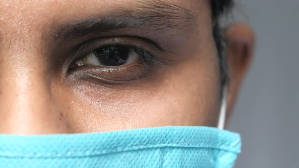 Close Up of Man with Protective Face Mask Looking at Camera 