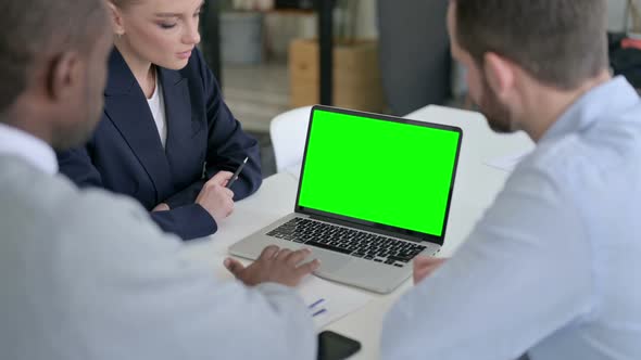 Rear View of Male and Female Business Person Using Laptop with Green Chroma Screen