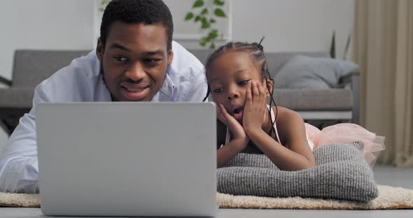 Young Black Man and Little Girl Afro American Father with Curious Emotional Daughter Looking at