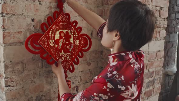 Chinese Woman Hanging Lunar New Year Ornament