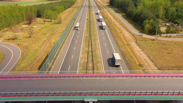 Traffic of cars and trucks on the Freeway in Summer day - top view shot. Top View shot of multi-lane