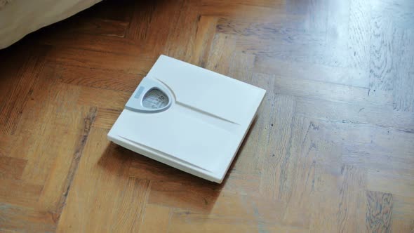 Woman Standing on Bathroom Scale