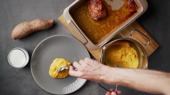 Top down view of serving delicious mashed sweet potato with coconut milk and roasted chicken.Clip re