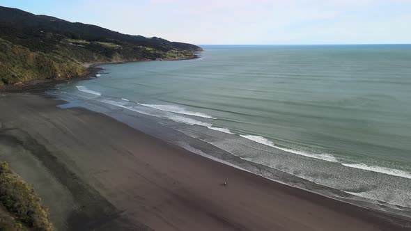 Cinematic flight over Raglan black sand beach along New Zealand's West coast