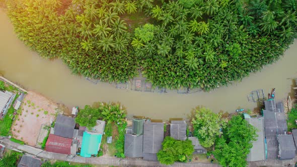 An aerial view over a fishing village by a canal in the countryside