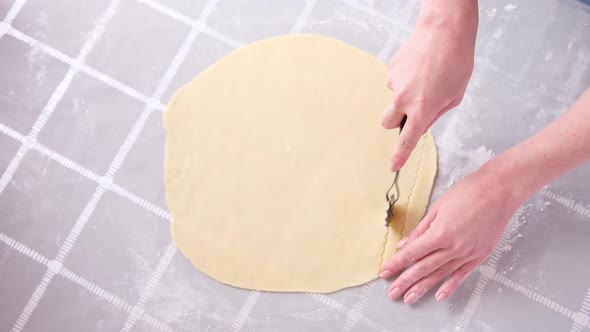 Apple Pie Cake Preparation Series  Woman Slicing Rolled Dough with Rolling Knife