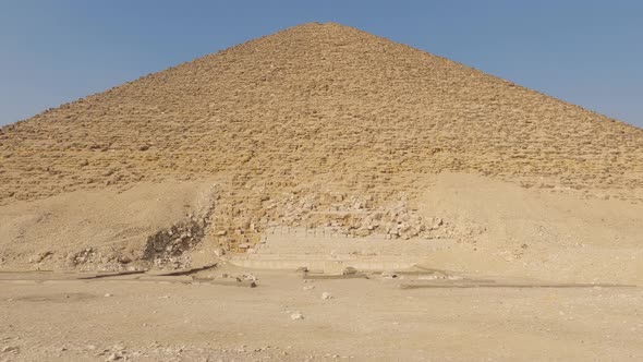 Tilt shot in front of the Dahshur Red Pyramid, clear, sunny day in Cairo, Egypt