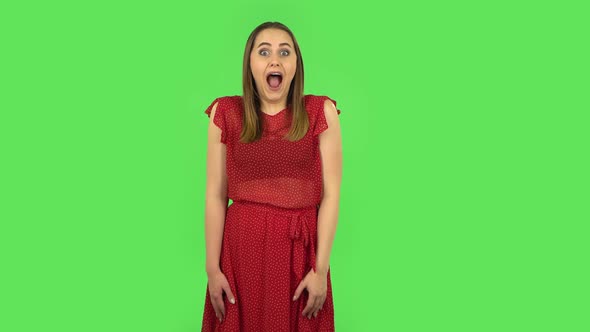 Tender Girl in Red Dress Is Saying Wow with Shocked Facial Expression. Green Screen