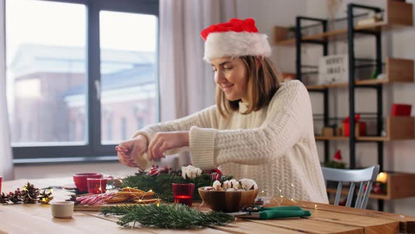 Happy Woman Making Fir Christmas Wreath at Home