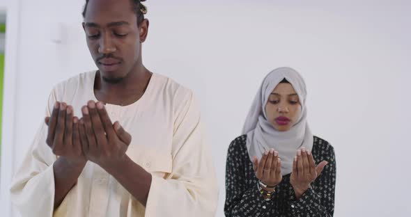 African Black Muslim Couple at Home in Ramadan Making Traditional Fatiha Prayer To Allah God While