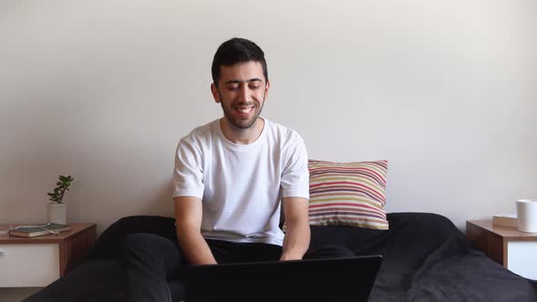 Young man acting fake during the end of an online video conference. Concept of falsehood, deception,