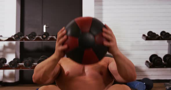 Man doing crunches with ball